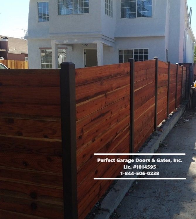 Custom Stained Horizontal Wood Fencing with Iron Posts