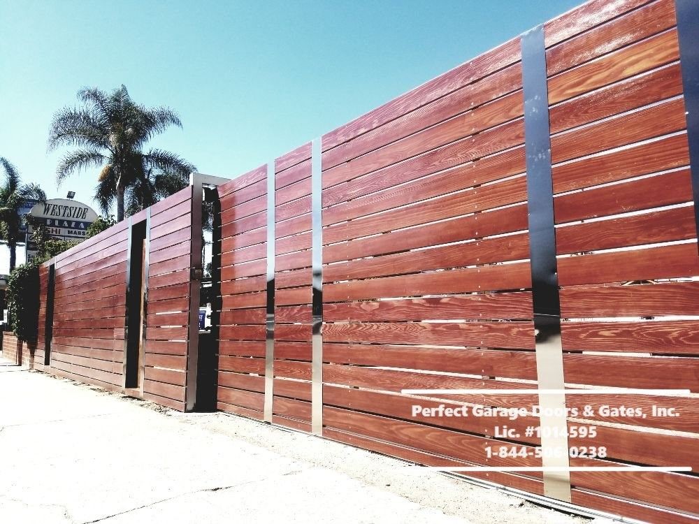 Custom Stained Horizontal Wood Sliding Driveway Gate with Decorative Vertical Iron Flat Bars