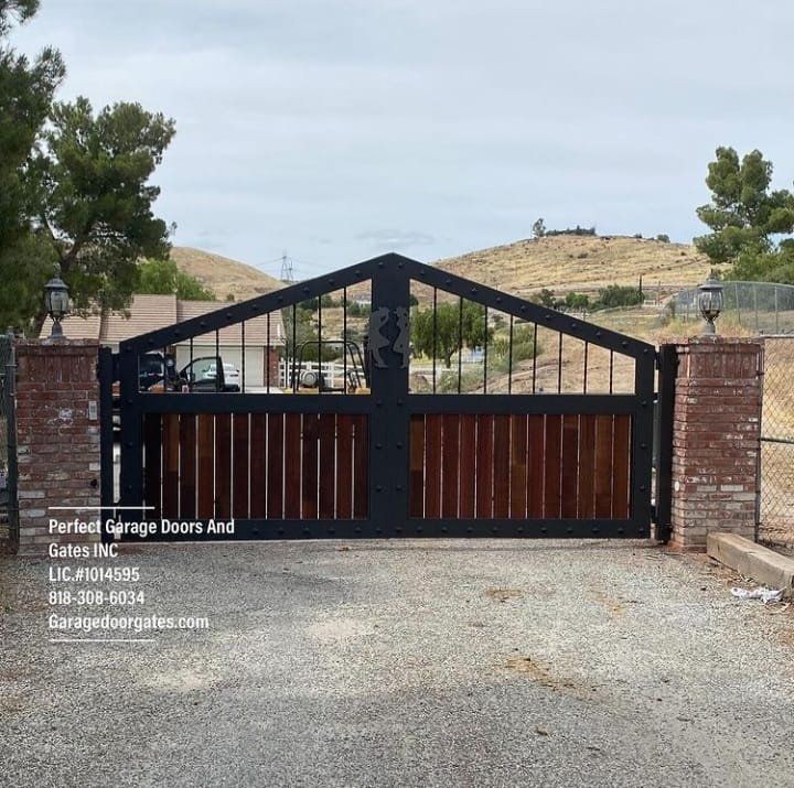 Custom Stained Vertical Wood Double Swing Driveway Gate with Iron Frame Pointed Arch and Ornaments