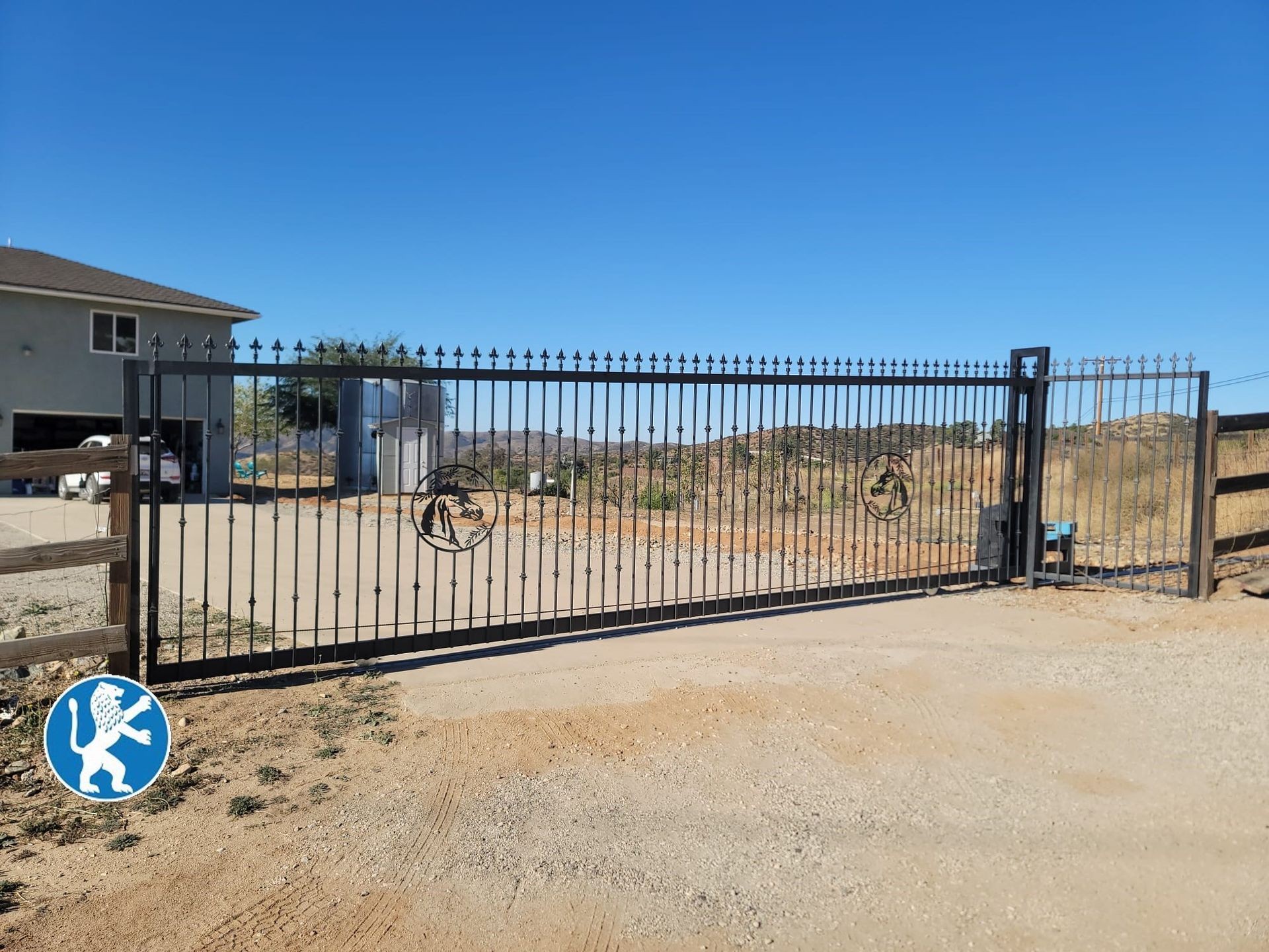 Custom Vertical Iron Sliding Driveway Gate with Ornamental Pieces, Knuckles, and Spikes